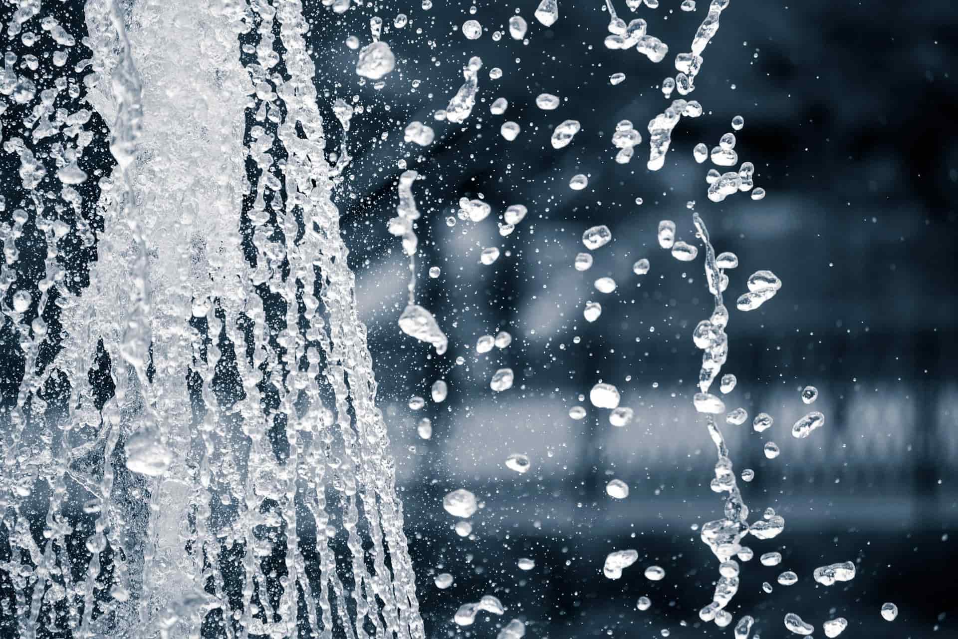 Water splashing and catching the light in a shallow basin on a cold, overcast day.