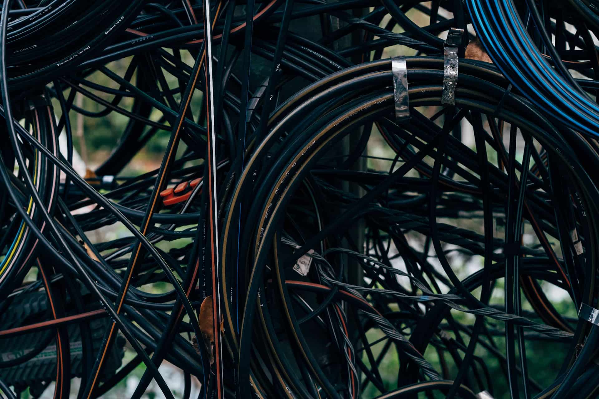 An outdoor electrical cable running along the ground beside a garden path.